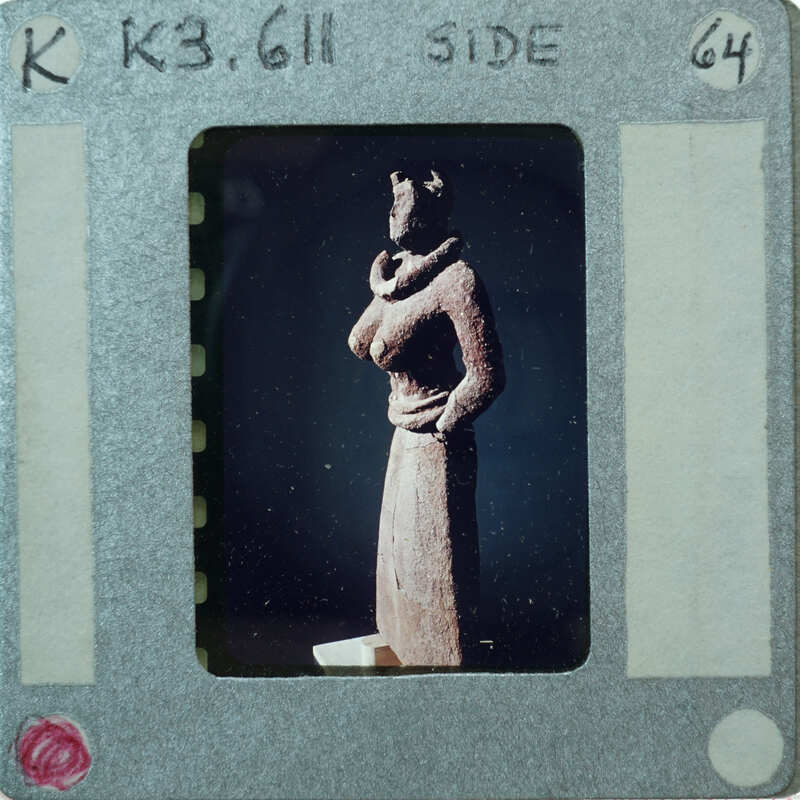 Detail of almost complete terracotta figurine from the side minus right arm.