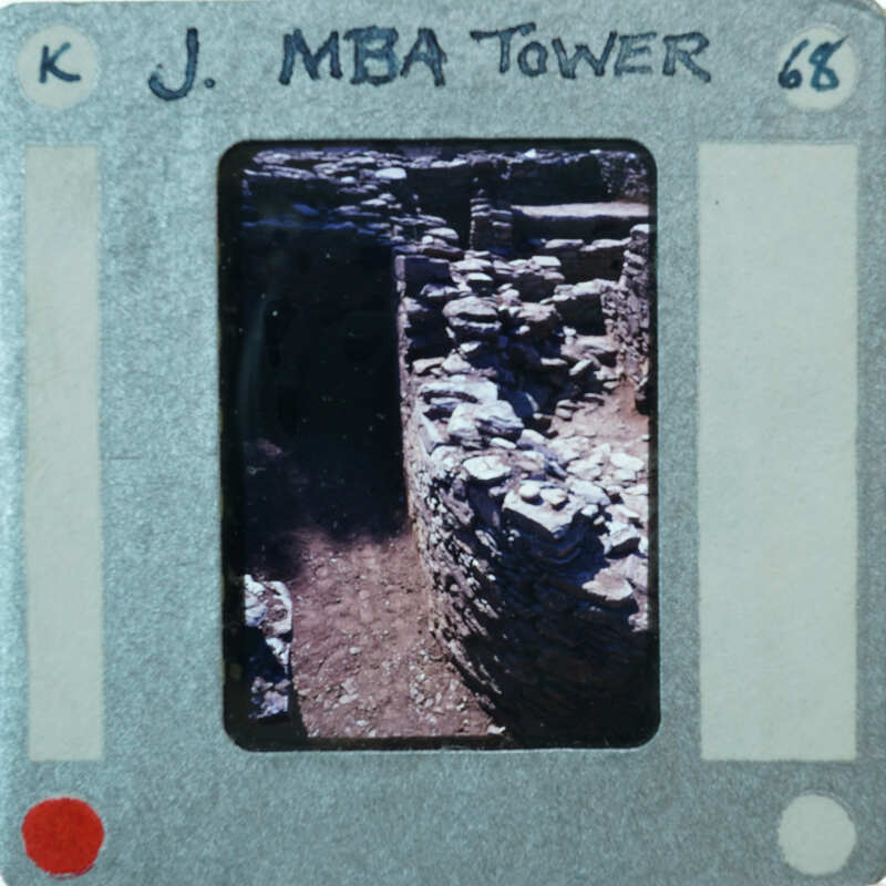 A photograph of a stone wall with an old film strip border and labels.