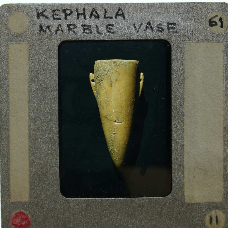 Marble vase in profile with black background.