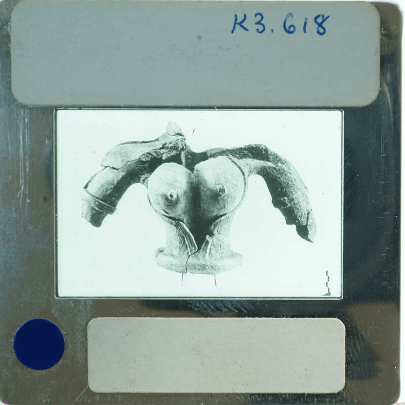 Terracotta figurine torso from front.