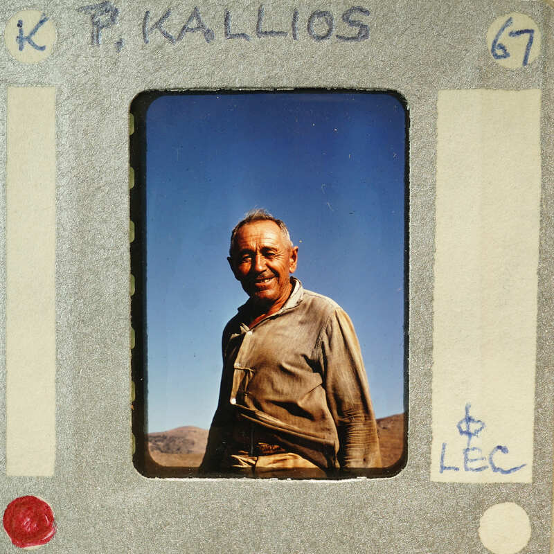 A man with a beard and mustache smiling at the camera.