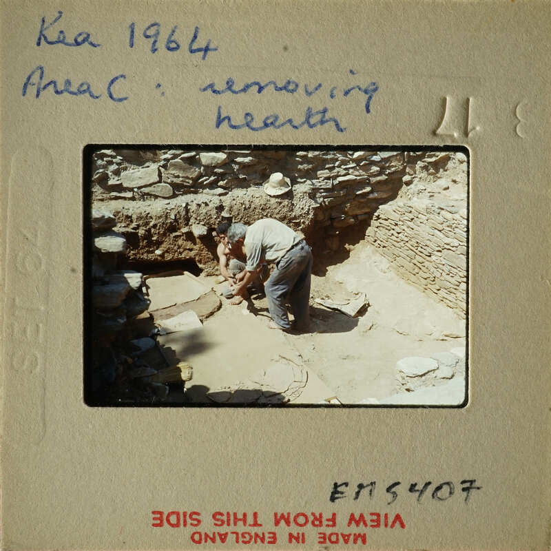 People working on excavation site, possibly removing health hazards from ruins.