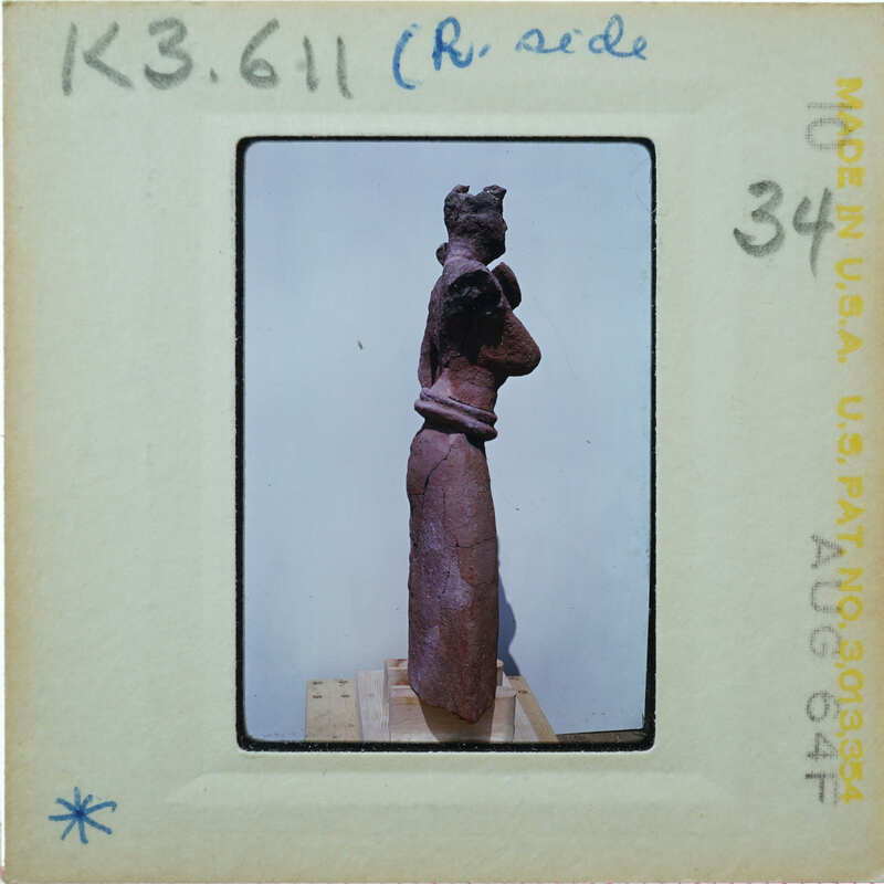 Detail of almost complete terracotta figurine from the side minus right arm.