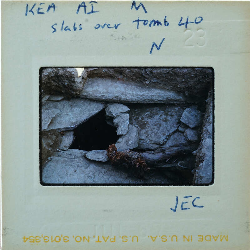A black and white photograph of a cave entrance with notes written on its border.