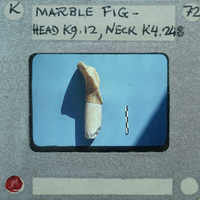 Broken head and neck of marble figurine.