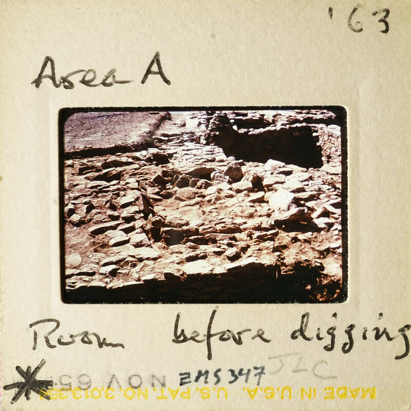 Old photograph of an excavation site with ruins and labeled as "Room before digging".