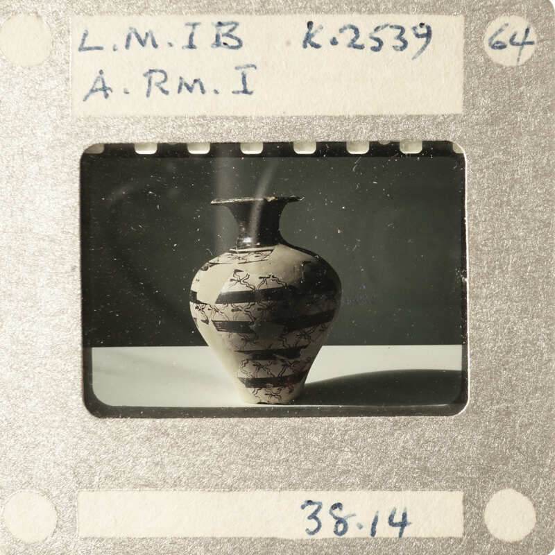 A vintage film strip with a single frame showing an old vase.