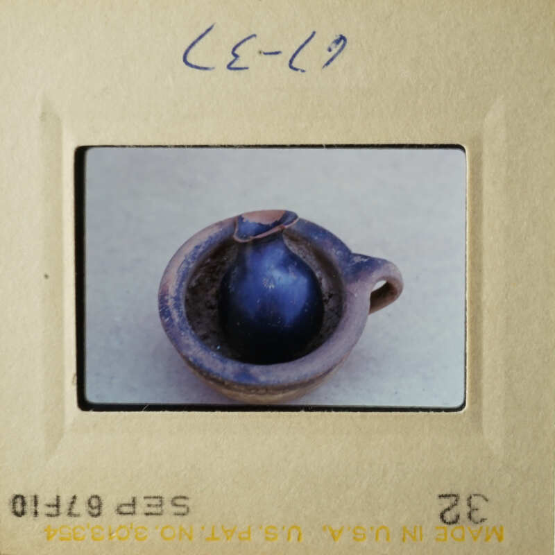 This is an image of a small blue vase placed on a table.