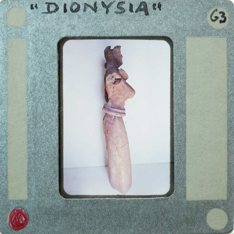 Detail of almost complete terracotta figurine from the side minus right arm.