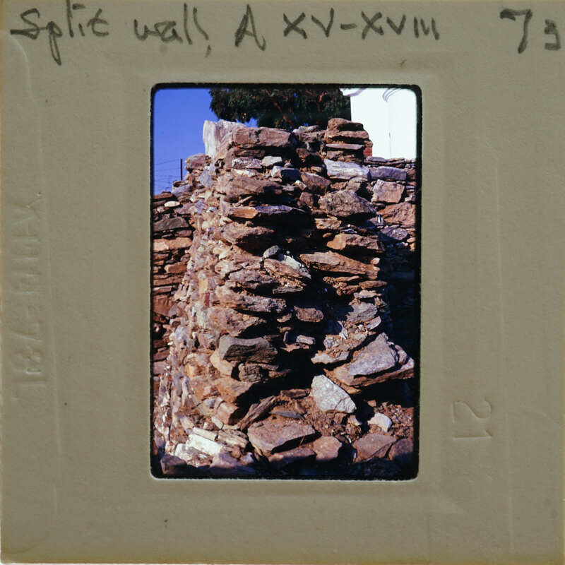 A photograph of a stone wall with an old, weathered appearance.