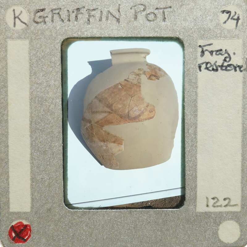 A damaged clay pot with a label indicating it's being restored.