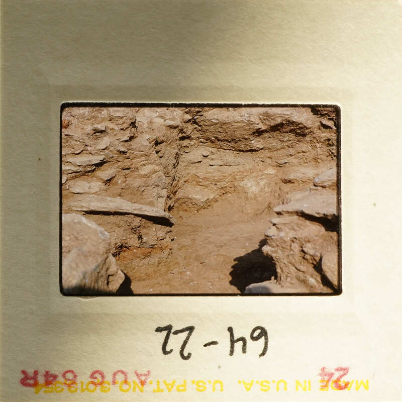 A photograph of a cave entrance with natural rock formations and sunlight filtering through.