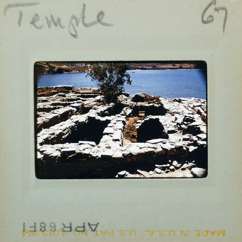 Old slide of a temple ruins by the water