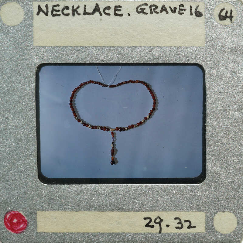 The image is a close-up of a beaded necklace.