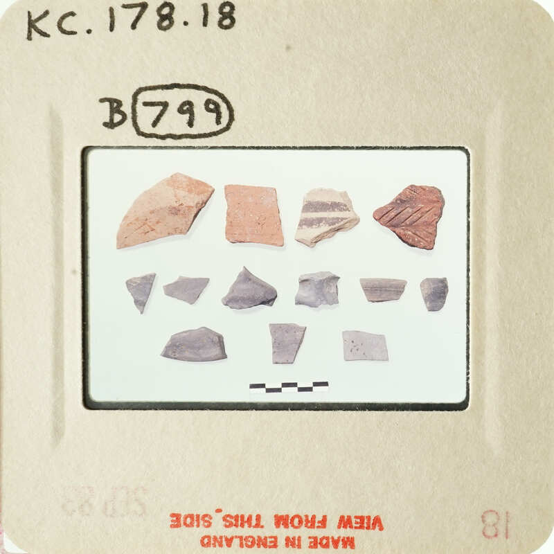 A collection of ancient pottery shards on display.