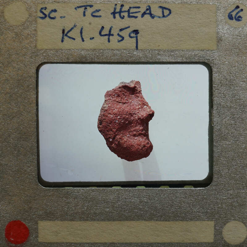 Broken fragment of terracotta figurine head (K1.459) in profile.