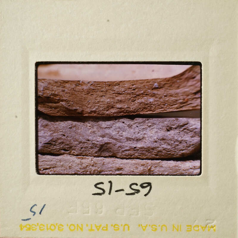 Close-up photograph of a pottery break surface on a film strip.