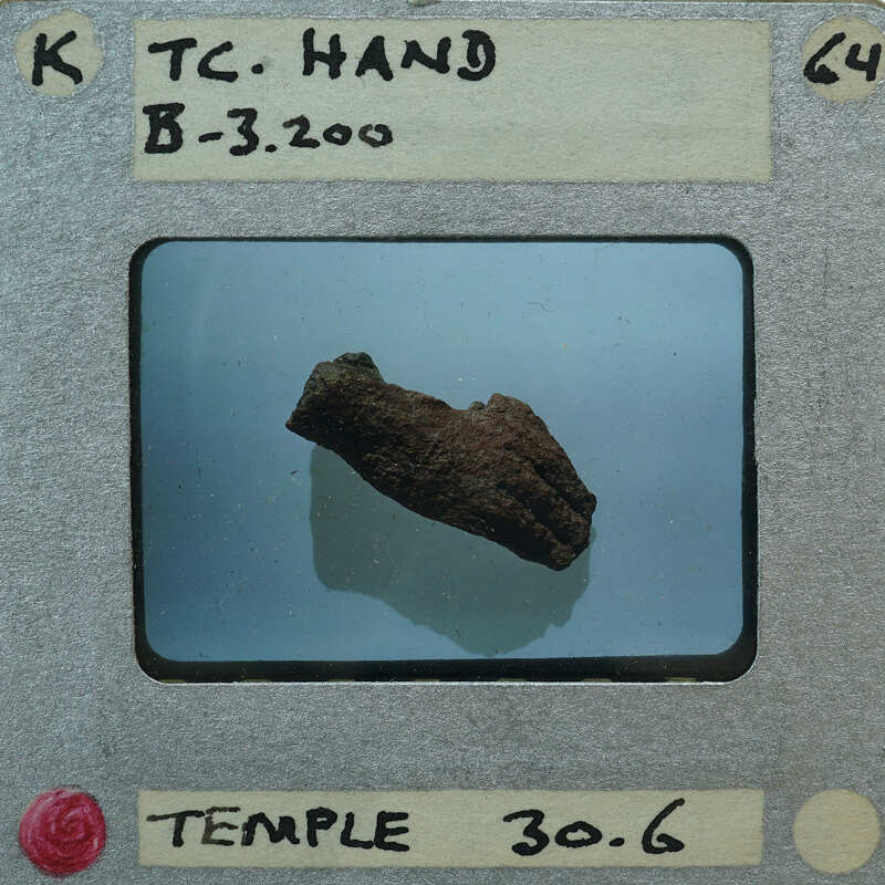 A photograph of a rock with a label identifying it as "Tc-Hand B-32000" from the Temple Temple, dated 30/6.