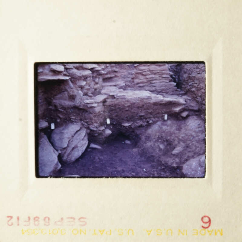 The photo shows an ancient cave with rock formations and natural light filtering through.