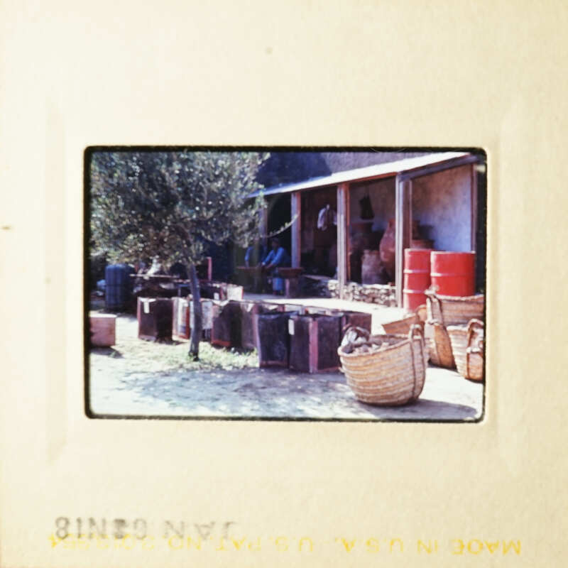 This photo captures an outdoor market scene with various goods and a building in the background.