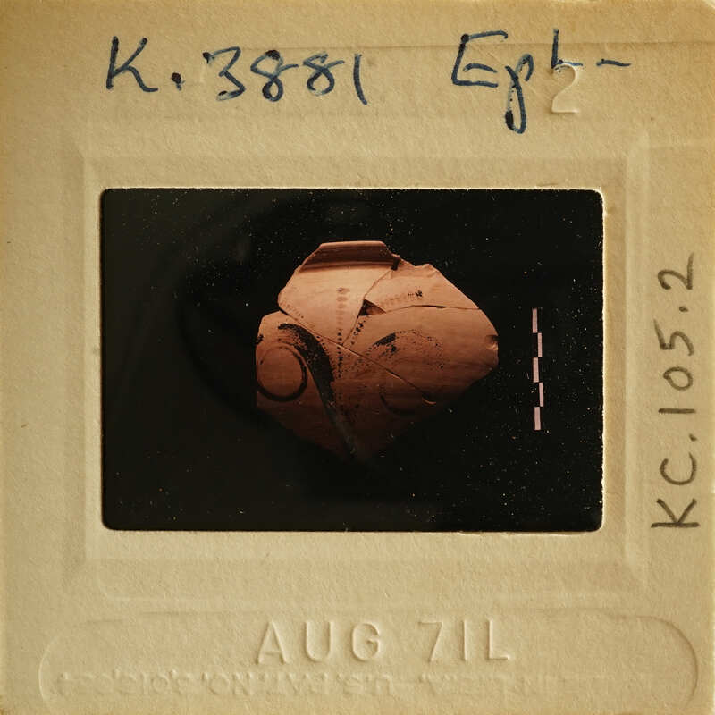 Ancient pottery with intricate designs on a black background, photographed and labeled as K.382971.