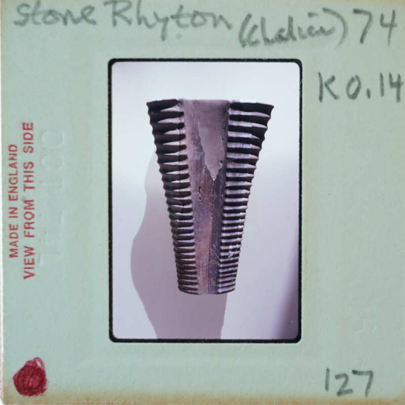 This is a photograph of an old, rusted metal object with ridges or teeth, possibly part of a machine or tool.