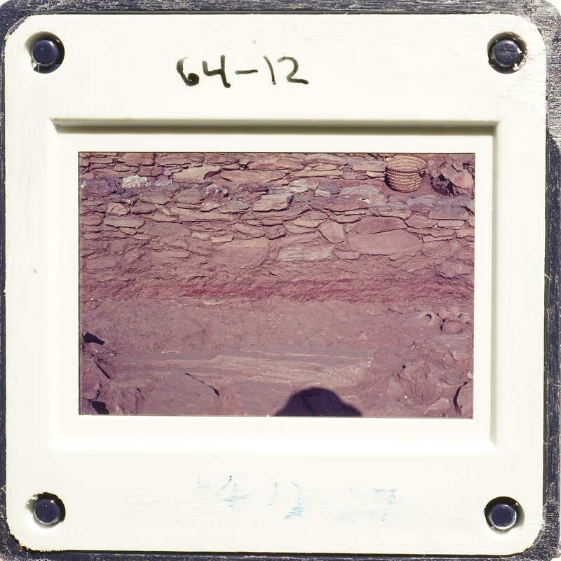 This is an image of a photograph depicting a rock formation with layers and shadows, possibly taken at a site like Mesa Verde National Park.