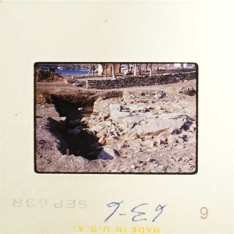 Ancient ruins with stone walls and pathways, possibly part of an archaeological site.