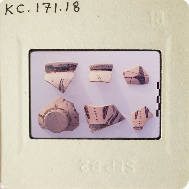A collection of ancient pottery shards with various patterns and designs.