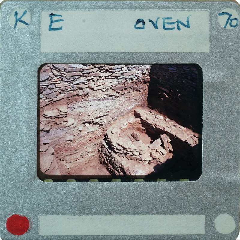 A photo of an oven with stones and a hole in the center, displayed on film.