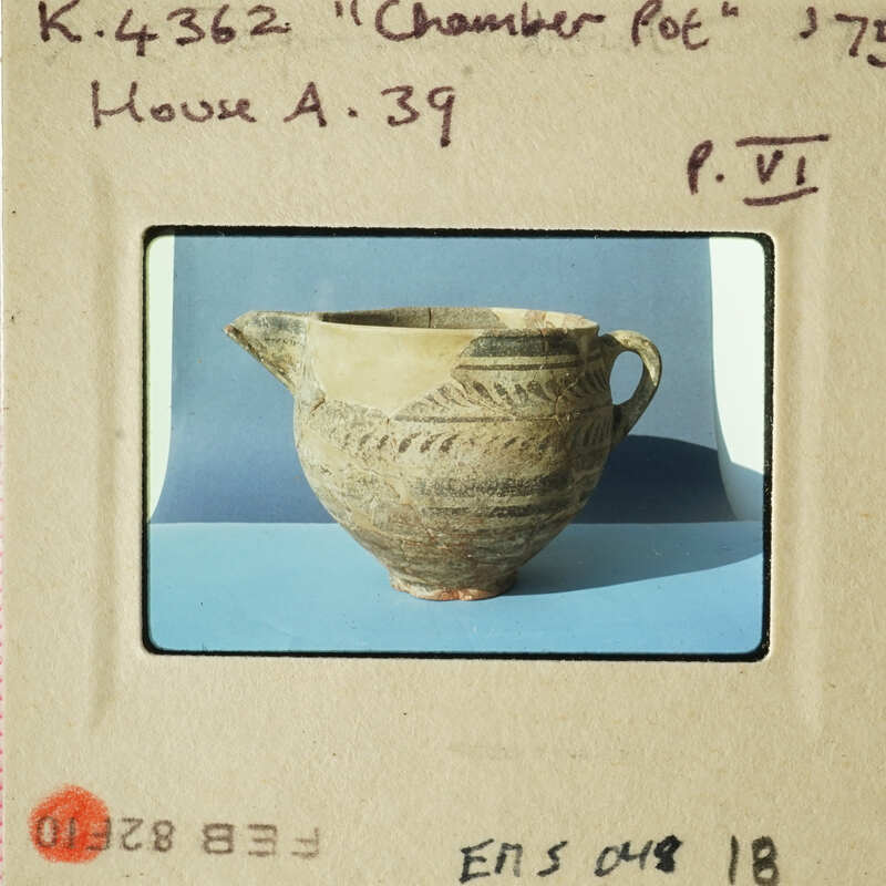Ancient pottery on display with label "Chamber Pot" and identification number.