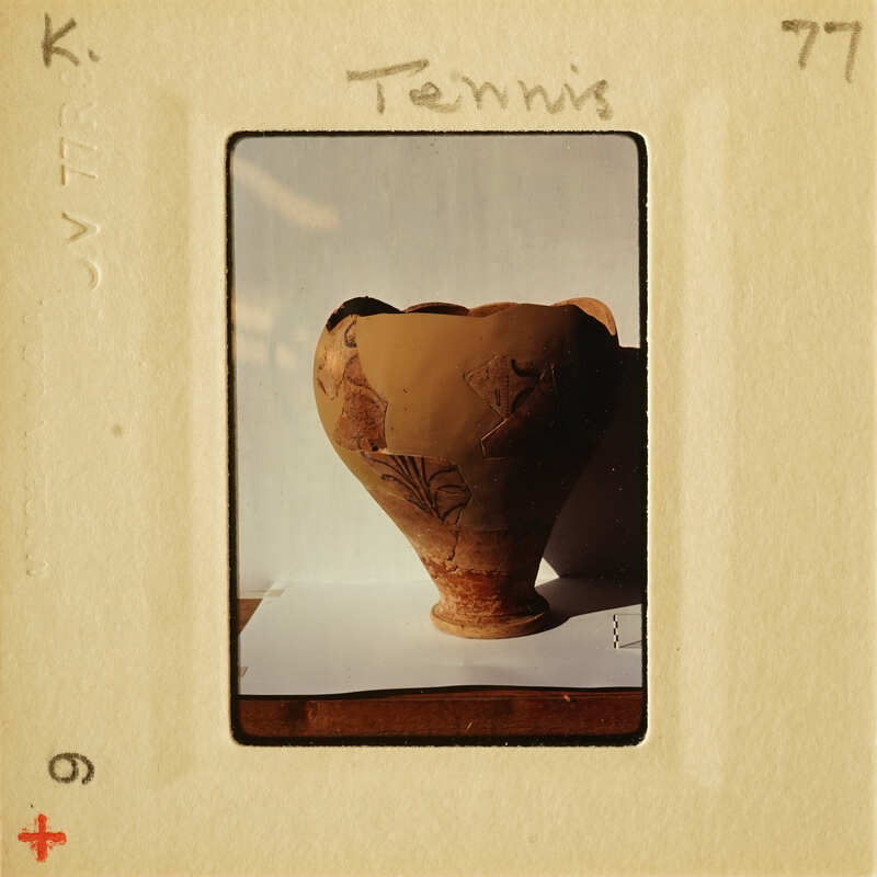 Ancient clay pot with intricate designs on display.