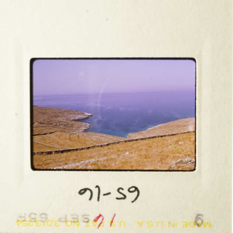 A scenic view of a coastal landscape with hills and water.