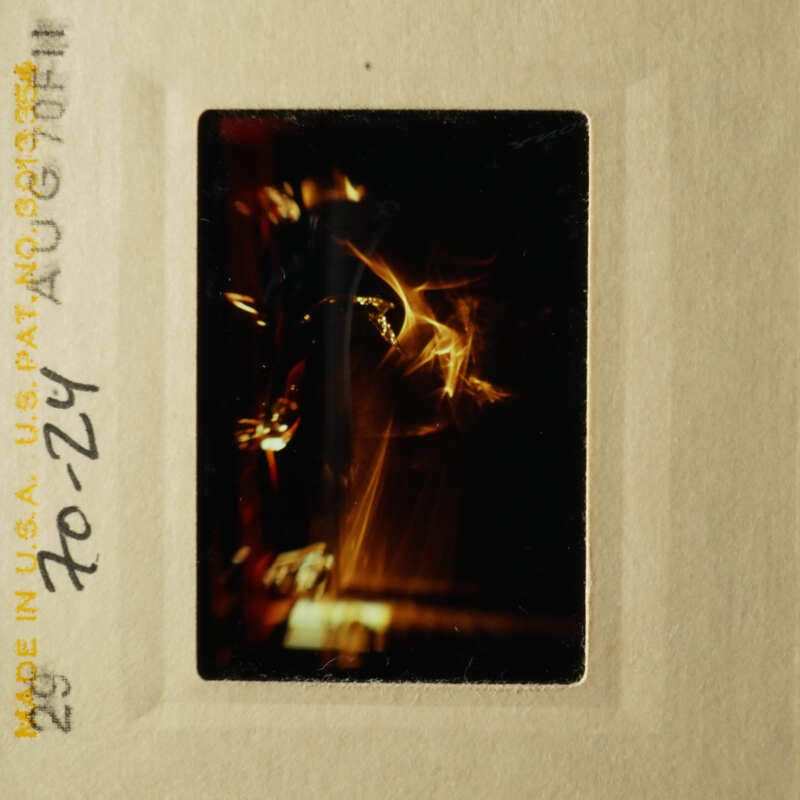 This is an old photograph depicting a blurry scene with indistinct objects and colors, likely capturing a moment from the past.