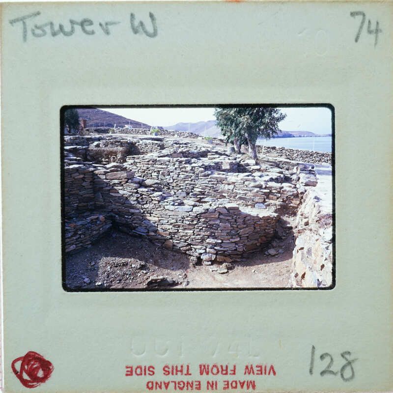 Old stone ruins of a building with vegetation growing on it, captured on an old film negative.