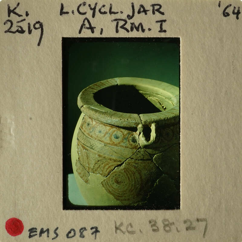 A photograph of an ancient pottery artifact with visible cracks and designs.