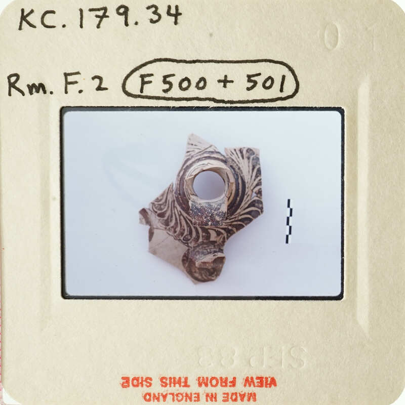 A small, intricately designed ring with an open center.