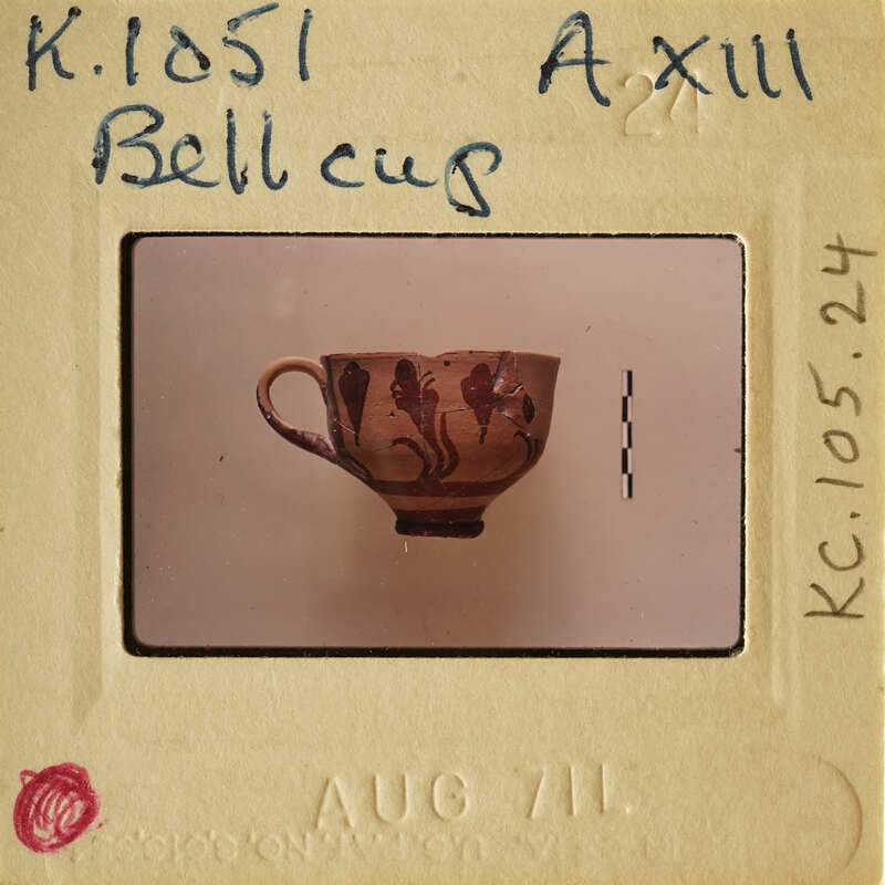A small, intricately painted ceramic cup on display.