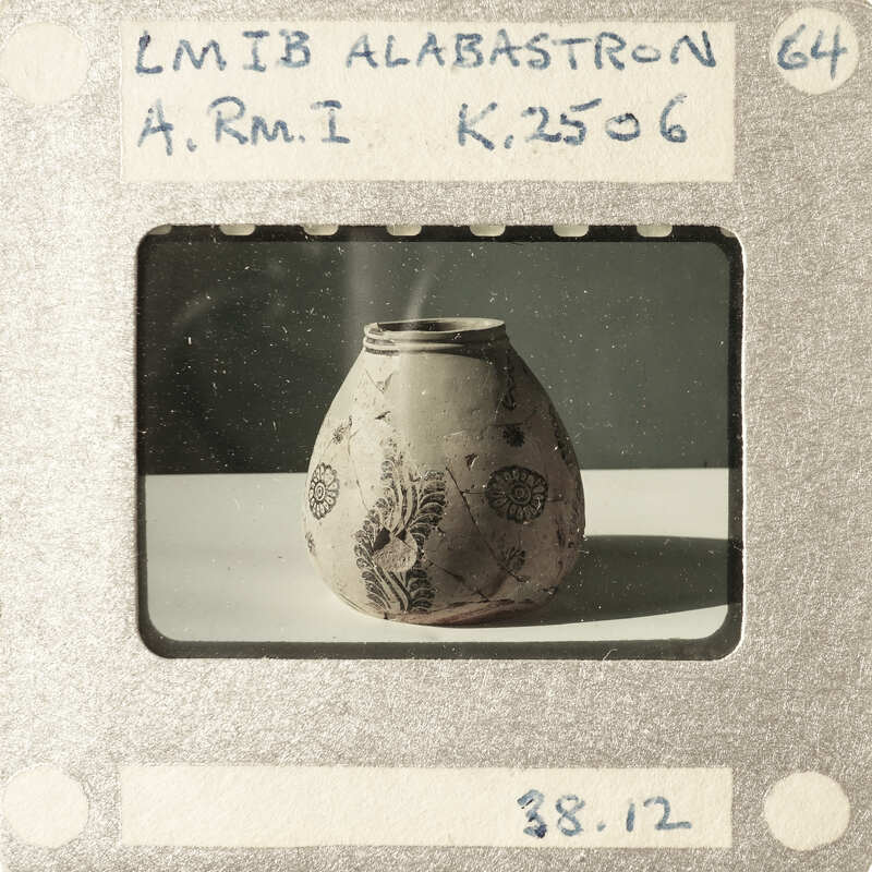 A small, ornate vase with a floral pattern on display.