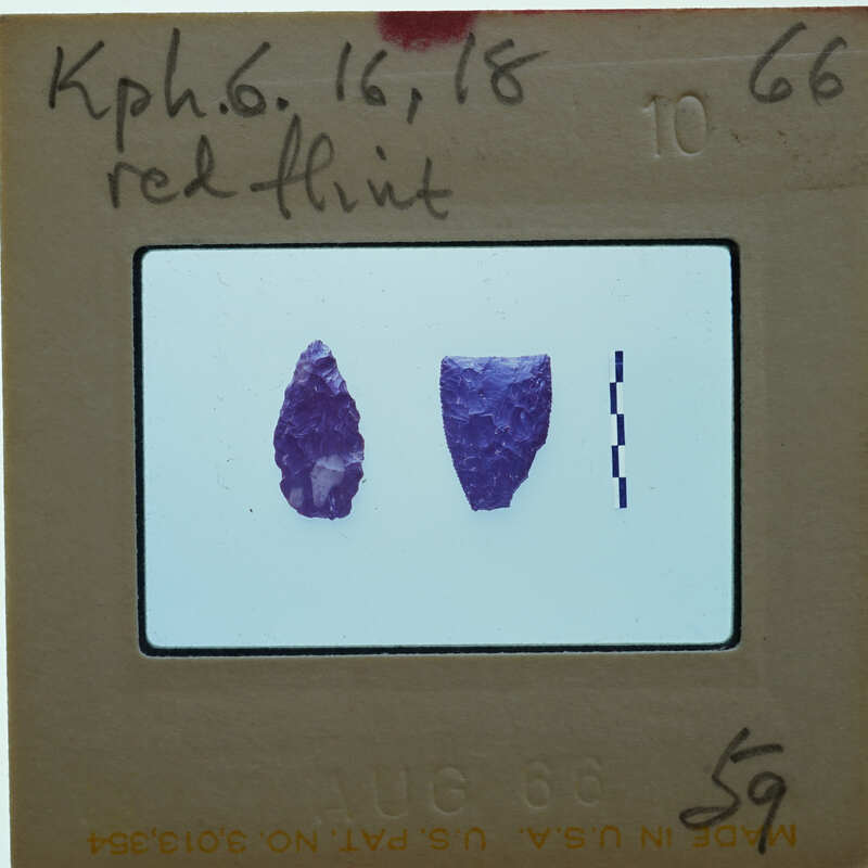 Image of a scientific slide with two purple flint stones on a white background.