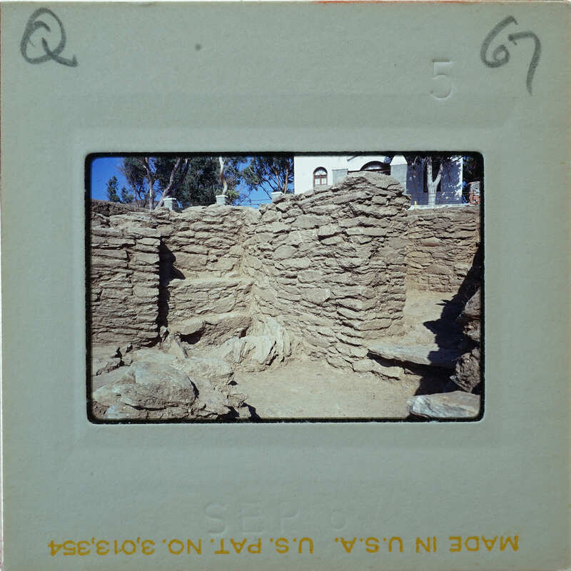 An old, crumbling stone structure with vegetation growing on it.