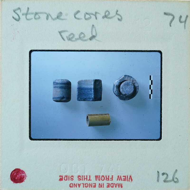 Assortment of cylindrical stone objects on table.