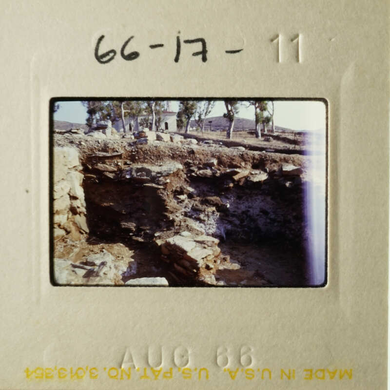This is an old photograph of a stone wall and ruins, possibly from an archaeological site.