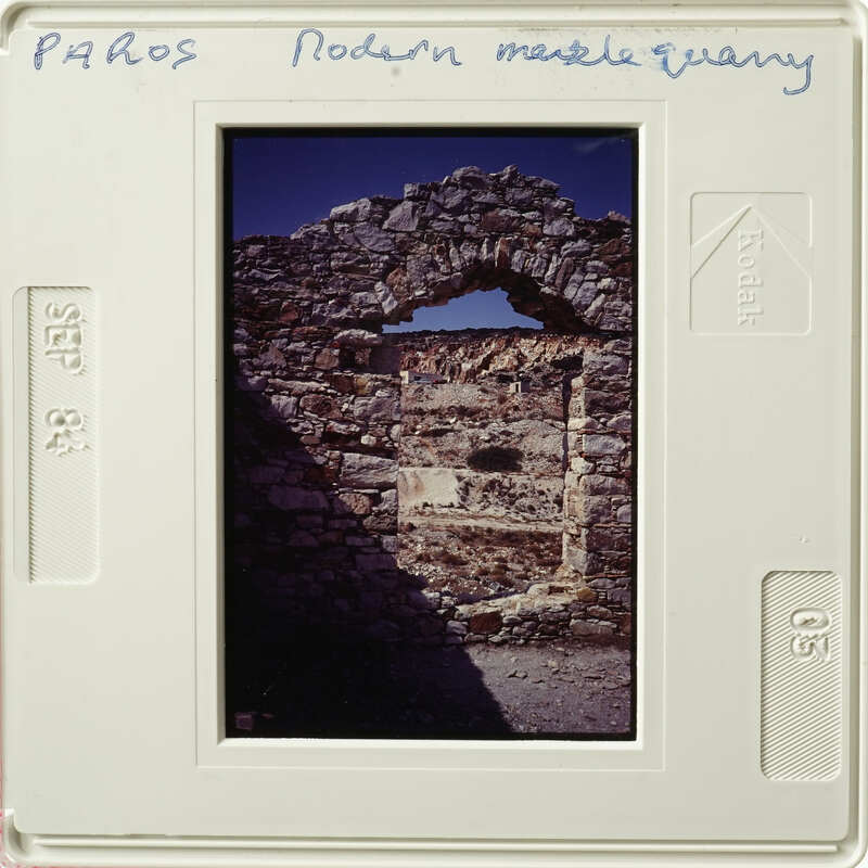 A photograph of an ancient stone archway with sunlight shining through.