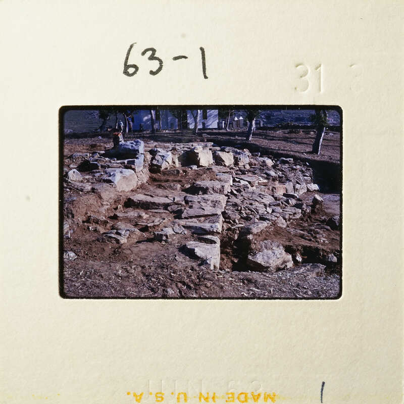 Old ruins with broken stones and dirt, possibly an archaeological site.