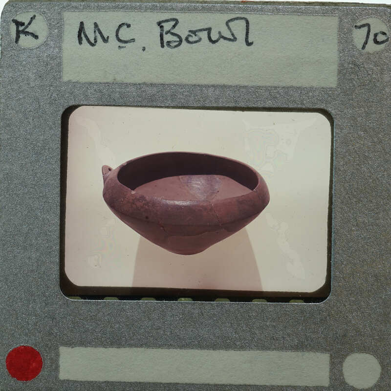 A brown clay pot showing opening on a white surface.