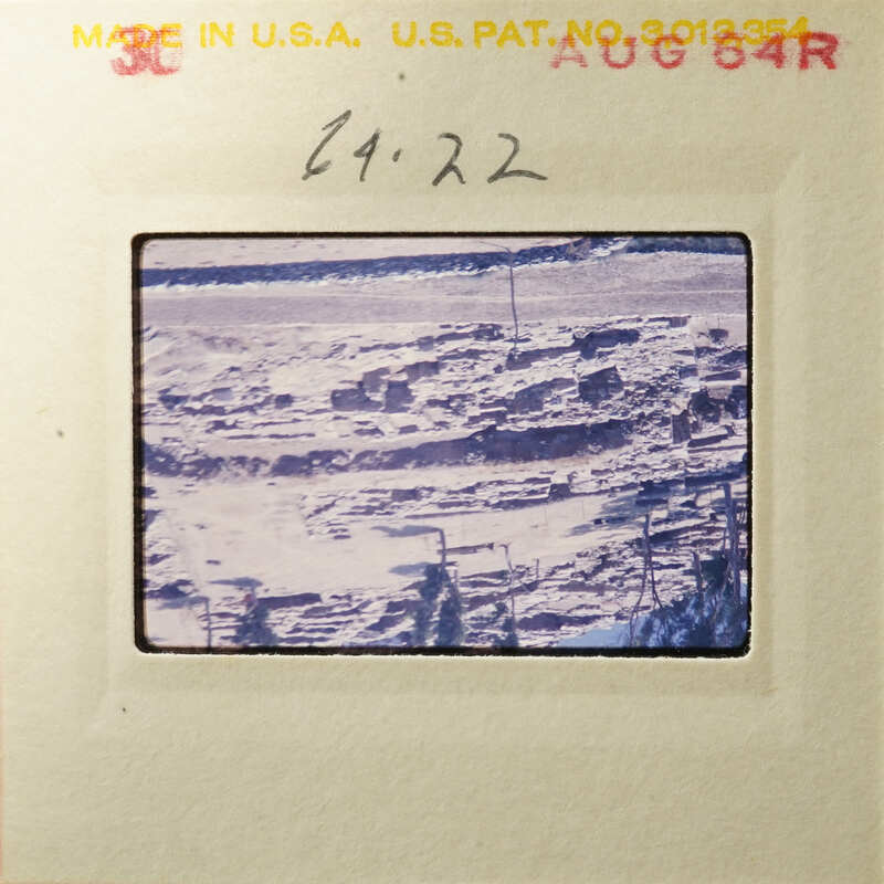 Aerial view of an abandoned mining site with piles of dirt and debris.