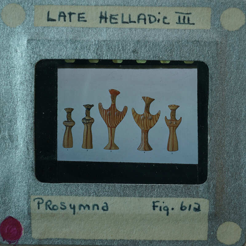 Picture of a projector screen displaying images of ancient figurines with labels.