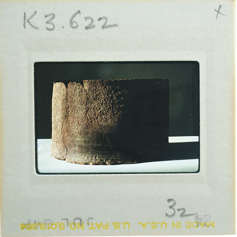 Broken base of terracotta figurine skirt.