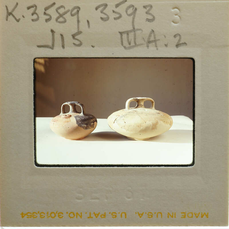 Two reassembled stirrup jars in profile on table, K.3589, K.3593.